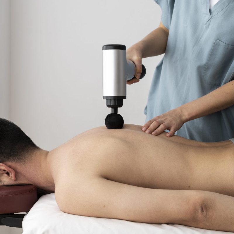 person-using-massage-gun